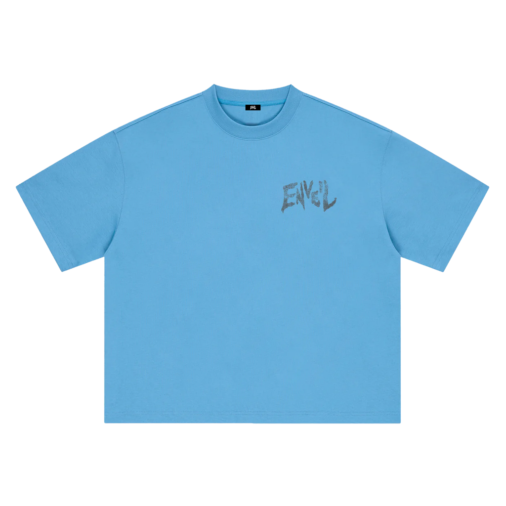 A sky blue short-sleeve crewneck t-shirt with a distressed dark grey 'ENVEIL' graphic printed on the left chest, displayed flat against a solid white background.